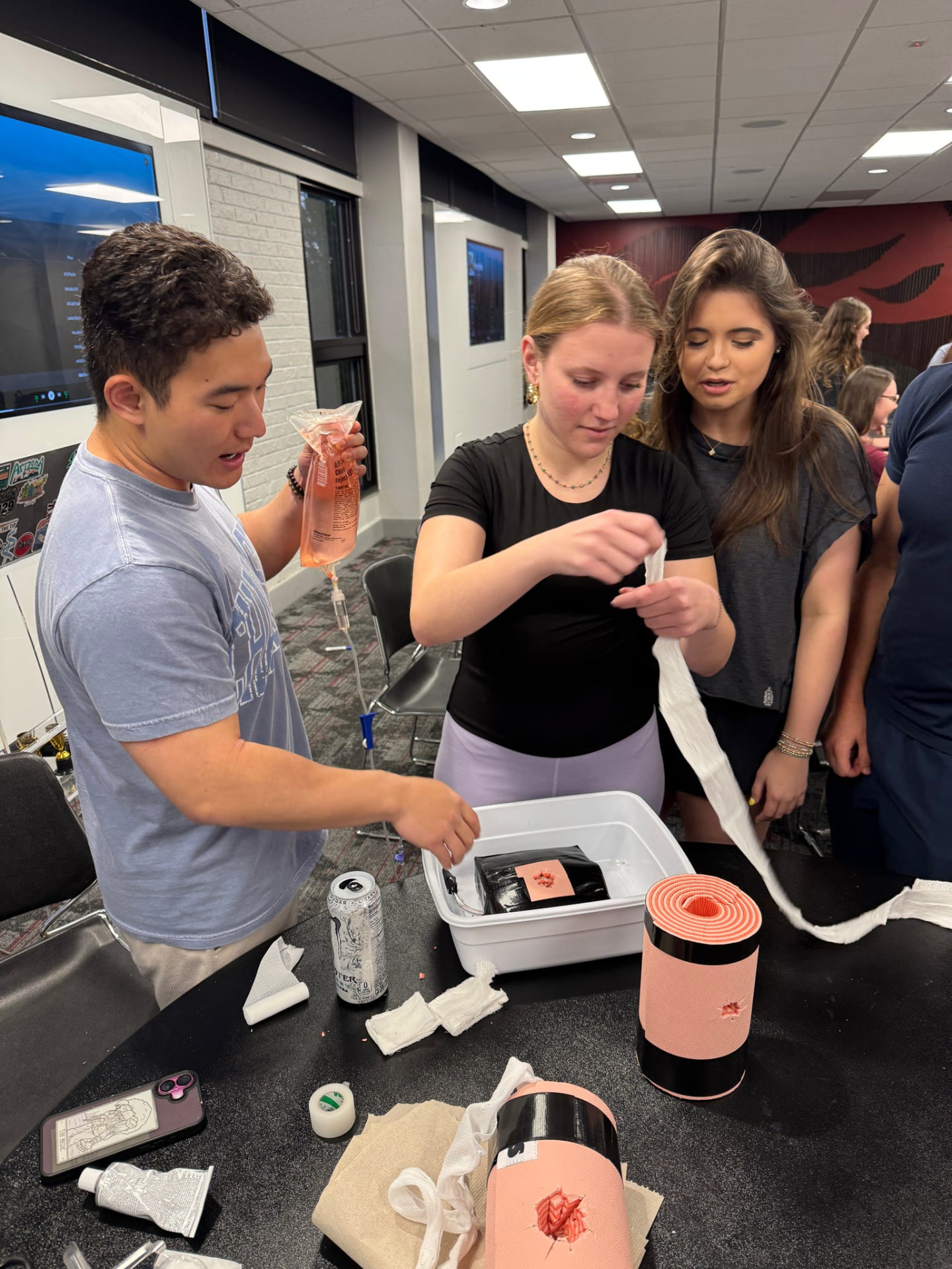 Students practicing wound packing during EMS training