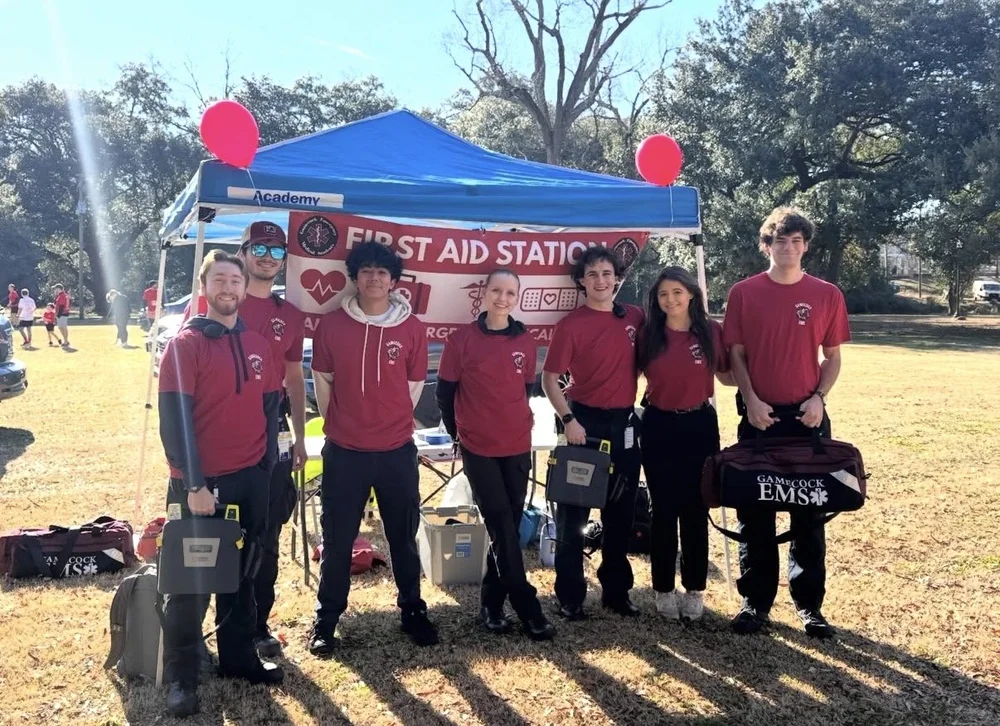 Gamecock EMS crew standing at the first aid station tent