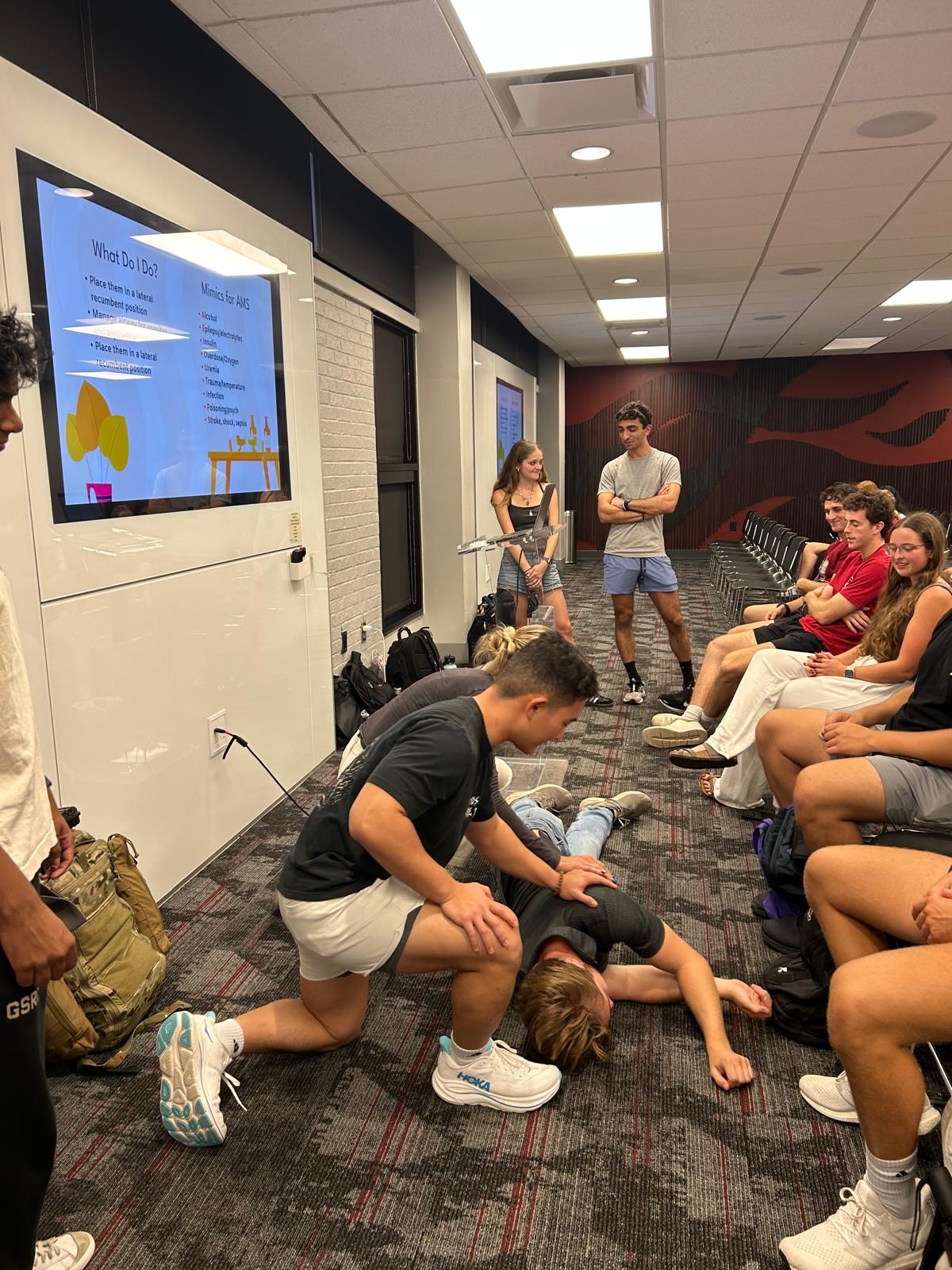 Students practicing recovery positioning